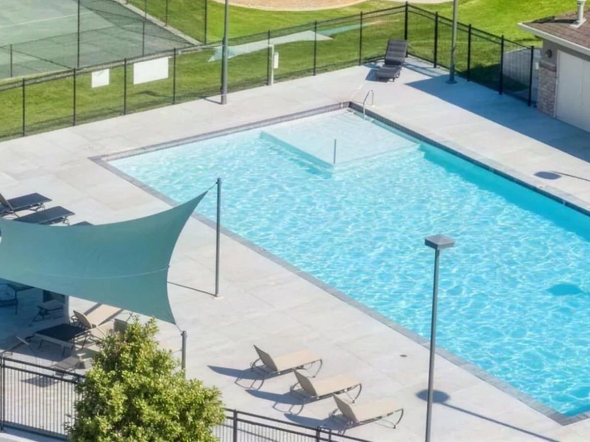 The community swimming pool, shade sails and pool deck